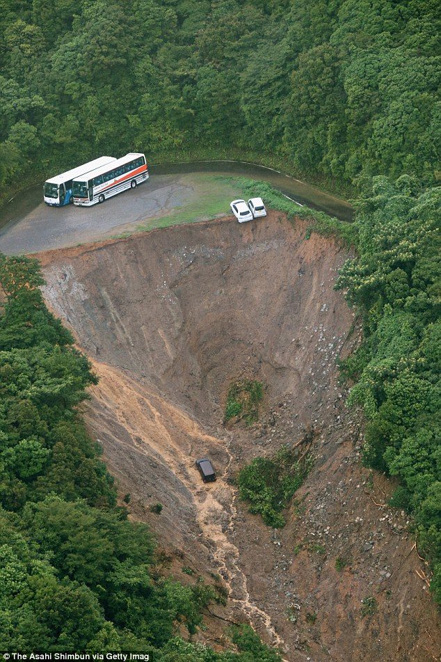 Busses trapped and vehicles hanging on the edge after mudslides in Japan.