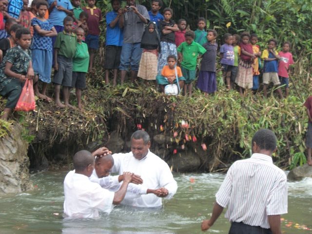 Baptism of new believers during the ceremony at the Imane Health Center.